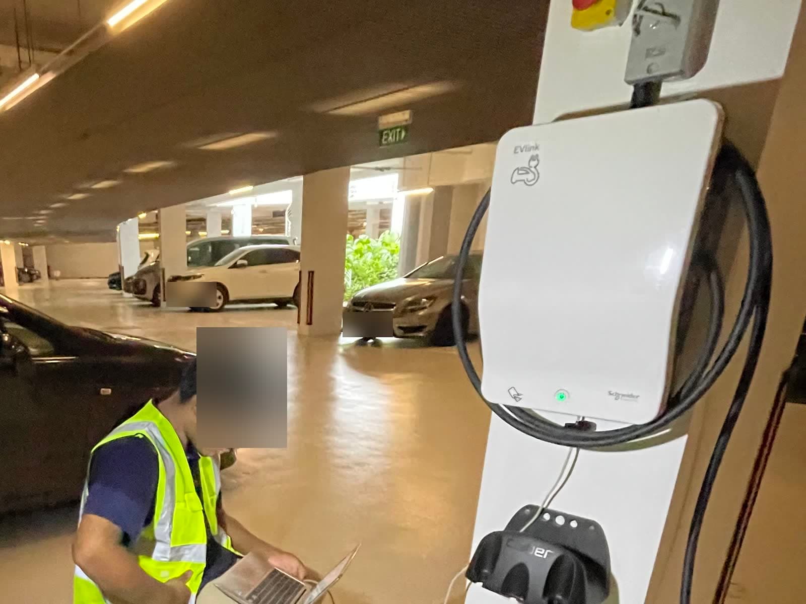 Pillar-mounted EV charger with a cable holster beside the parking bays at The Coast @ Sentosa Cove