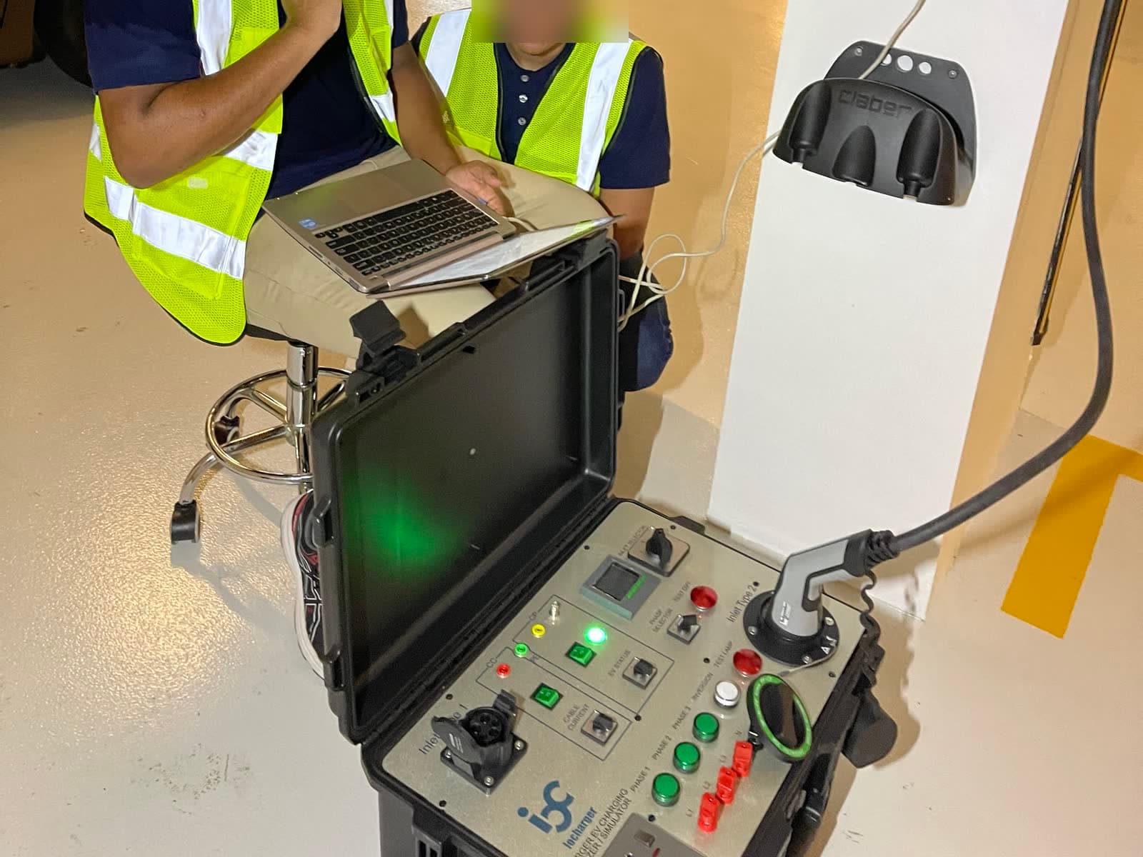 EV charger test unit plugged into a shared condo charger during a SuperCharge.SG inspection at The Coast @ Sentosa Cove